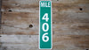 custom metal mile marker sign with a green background and white lettering