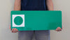 a man holding a custom metal green ski run sign with a green background with a spot for your custom text