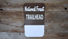 metal sign that says 'national forest trailhead' in white with a brown background with a space for a custom name