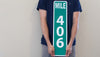 man holding a custom metal mile marker sign with a green background and white lettering