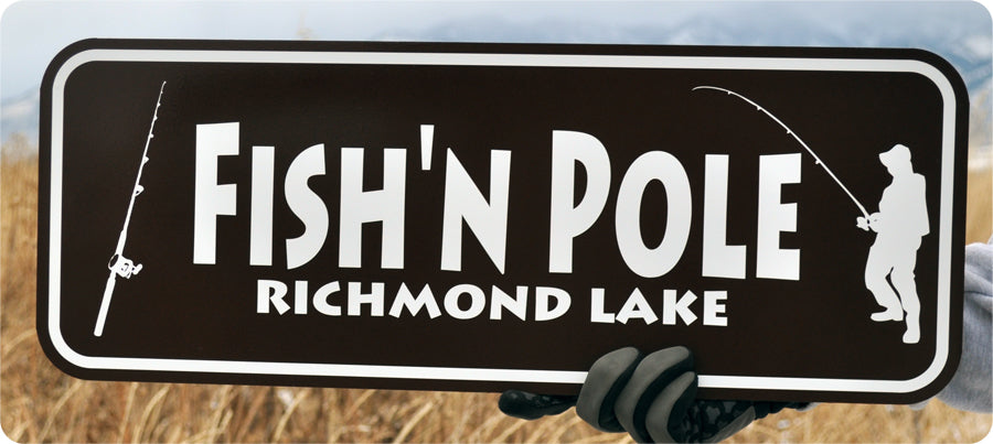 metal sign with white text that says 'fish'n pole' on a brown background