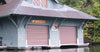 custom metal lake cabin sign that is brown and white hung up on a boat storage building