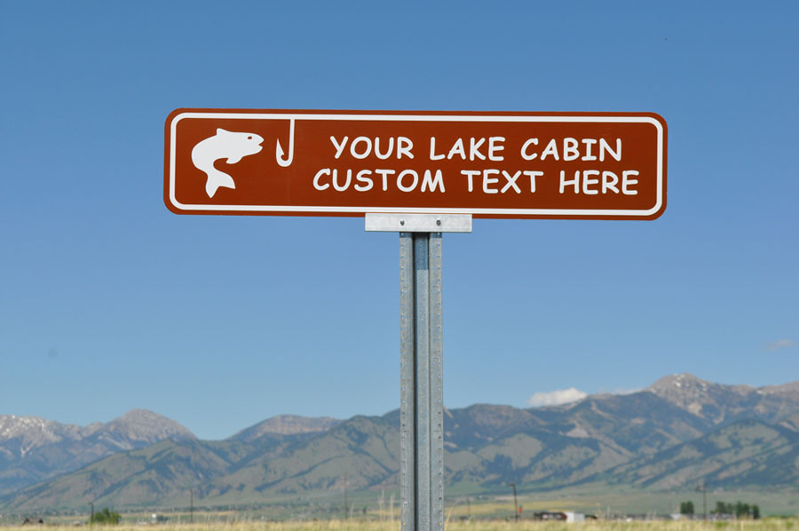 custom lake cabin sign with a brown background and white text that says 'your lake cabin custom text here' with an image of a fish and hook in white