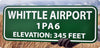 metal sign with white text that says 'whittle airport' with a green background