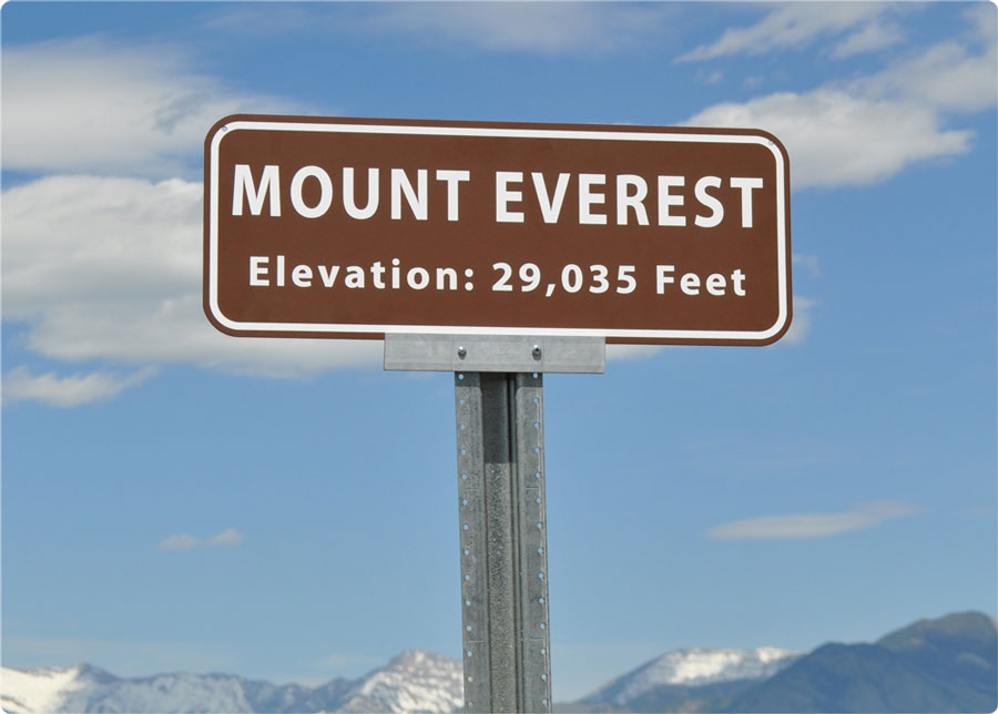Mount Everest elevation metal sign with a brown background and white text